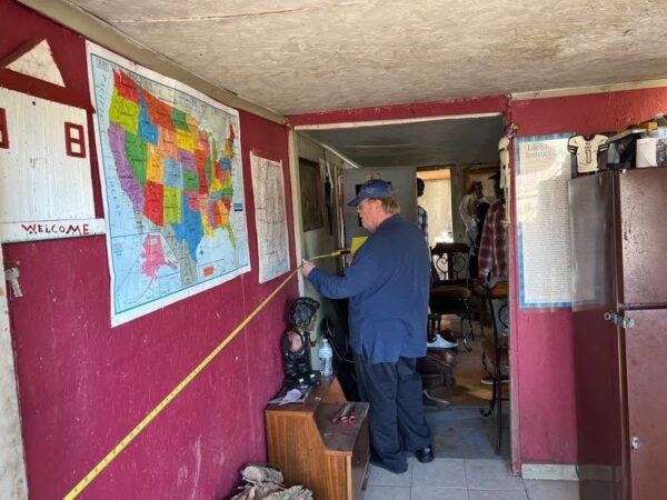 IMG_8022 Dr. West takes measurements of the Chatmon jook (Photo: © T. DeWayne Moore, 2023)